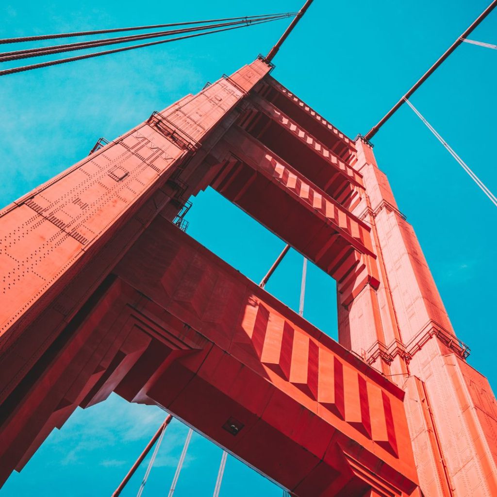 Upward view of the Golden Gate Bridge in San Francisco against a clear blue sky